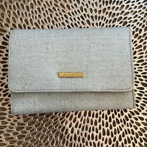 Wallet that’s Cream colored with hints of grey and gold